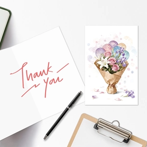Flat lay of watercolor floral thank you greeting cards with elegant fountain pen