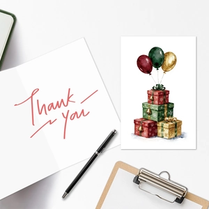 Detailed close-up of a watercolor birthday card set with Thank You calligraphy on desk