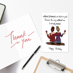 Flat lay of friendship birthday card set with thank you note and stationery on white desk