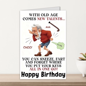 Funny old man birthday card with humorous sneezing illustration on wooden surface