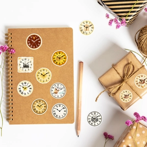 Close-up of vintage steampunk clock and navigation stickers on a kraft notebook