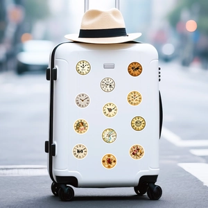 Close-up of vintage clock and travel stickers applied on a white minimalist suitcase