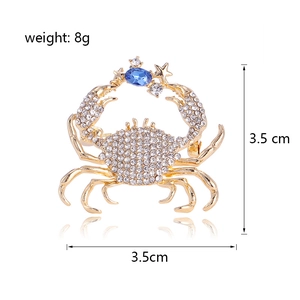 Exquisite gold crab brooch with diamonds, blue gemstone, and star detail, 3.5cm x 3.5cm size