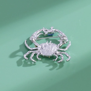 Back view of silver crab brooch with secure pin clasp and colorful rhinestone accents