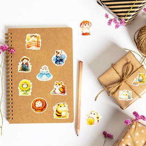 Detailed application of cute hamster stickers on kraft notebook and gift boxes