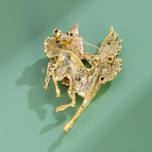 Reverse side of golden Pegasus brooch showing detailed metal texture and pin clasp