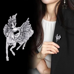 Retro silver Pegasus brooch featuring detailed wing texture shown on model and as flat lay