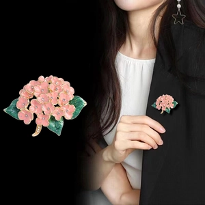 Detail of pink hydrangea flower brooch with crystal rhinestones on black suit blazer