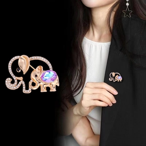 Elegant elephant brooch with rose gold finish and colorful crystals on a black blazer