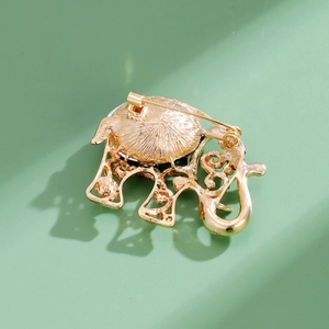Back view of vintage gold elephant brooch showing detailed alloy structure and safety pin