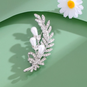 Luxury silver wheat ear leaf brooch with pearls and rhinestones on green background