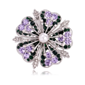 Elegant floral brooch featuring violet crystals and a pearl on a silver alloy base
