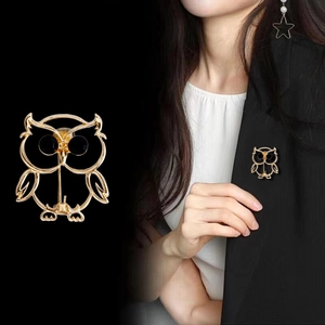 Macro detail and model view of a gold hollow owl brooch with black round eyes