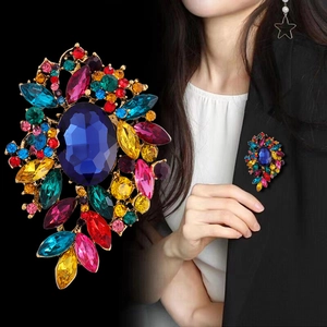 Elegant multi-color crystal glass brooch with large blue oval gemstone for suit lapels