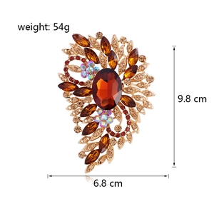 Ornate amber crystal floral brooch in gold plating measuring 9.8cm by 6.8cm