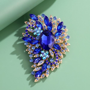 Vintage floral brooch with large oval blue crystal and sapphire rhinestones in gold alloy