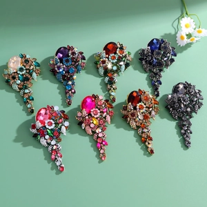 Elegant vintage crystal brooches with rhinestone accents in multiple vibrant colors