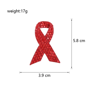 Detailed size view of red ribbon HIV awareness brooch with red rhinestones and 17g weight