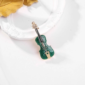 Artistic green enamel violin brooch with gold floral engraving on a vintage frame