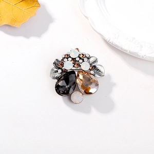Vintage silver crystal brooch with amber and grey teardrop gemstones in a layered design
