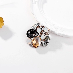Elegant vintage silver crystal brooch with water-drop gemstones on decorative plate