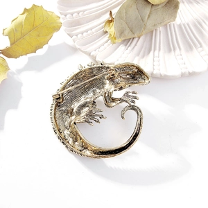 Macro detail of lizard brooch back with vintage gold finish and pin fastener