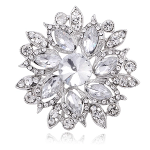 Macro detail of vintage floral brooch with clear rhinestones and silver alloy base