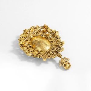 Vintage gold alloy brooch back view with intricate patterns and teardrop pendant charm