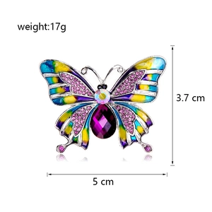 Detailed view of enamel butterfly brooch with dimensions 5cm by 3.7cm and 17g weight