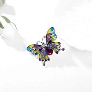 Enamel butterfly brooch with purple crystals on a white floral background display