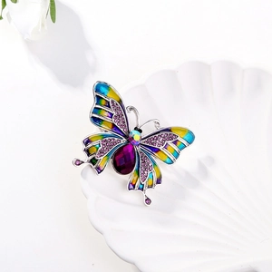 Exquisite vintage enamel butterfly brooch with purple gemstone and crystals in a white shell dish