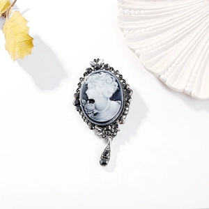 Detailed close-up of Victorian style cameo brooch with black crystals and drop pendant
