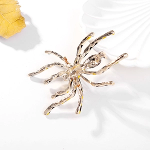 Detailed back view of golden spider brooch showing pin fastener and enamel finish