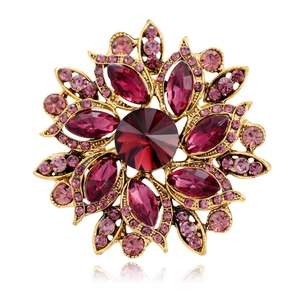 Macro view of vintage flower brooch featuring dark red crystal and pink rhinestones