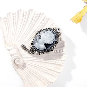 Detailed macro view of vintage cameo brooch with lady profile and rhinestone frame