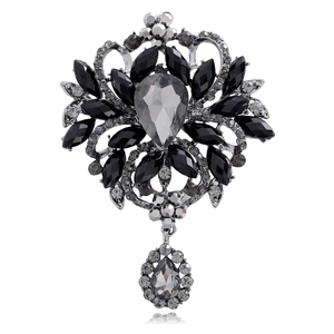 Detailed macro of vintage silver flower brooch with grey pear-shaped crystals and rhinestones