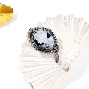 Detailed macro view of an elegant Victorian style cameo brooch with crystal accents