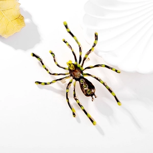 Vintage oversized spider brooch with green crystals and black enamel on gold metal base