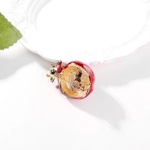 Back view of a pomegranate brooch showing golden alloy base and secure metal pin clasp