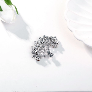 Macro view of crystal tree brooch back featuring a secure safety pin clasp and silver finish