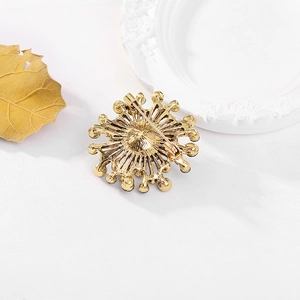Detail view of the golden alloy brooch back showing the secure metal pin closure