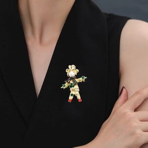 Vintage scarecrow brooch with pearl head and colorful crystal accents on a black blazer