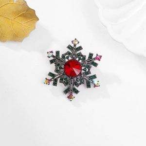 Snowflake brooch with red and green rhinestones on gunmetal base for elegant winter styling