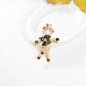 Vintage scarecrow brooch with gold alloy pearls and crystals on a white background