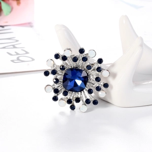 Fashion geometric starburst brooch with blue crystal center on silver alloy base