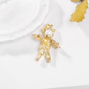 Vintage gold scarecrow brooch with pearl, back view showing the pin fastener on white background