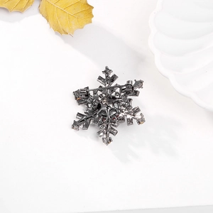 Detailed back view of a snowflake brooch featuring a durable metal safety pin closure