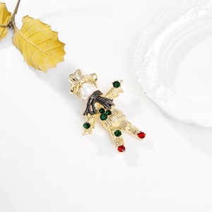 Detail of vintage scarecrow brooch with pearl head, colorful rhinestones and black scarf