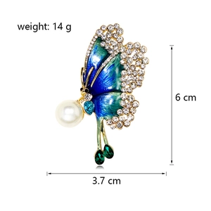 Enameled butterfly brooch with rhinestones, pearl accents and green teardrop charms
