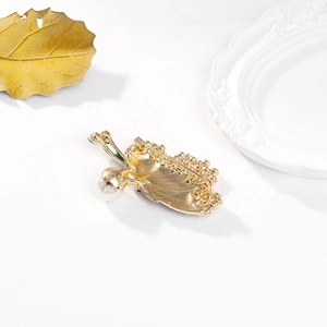 Exquisite butterfly brooch with green gemstone, large white pearl, and gold metal pin